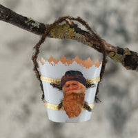 Decorative ornament with a n antique Santa Claus image  on a branch