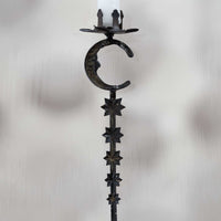 Decorative candle holder with star and moon design on a white background