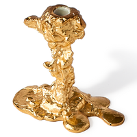gold colored drip candle stick holder design object