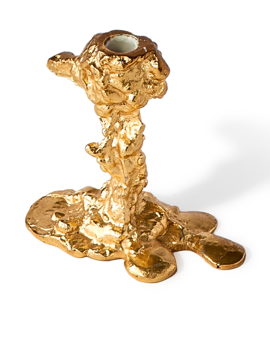 gold colored drip candle stick holder design object