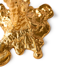 detail of gold colored drip candle stick holder design object