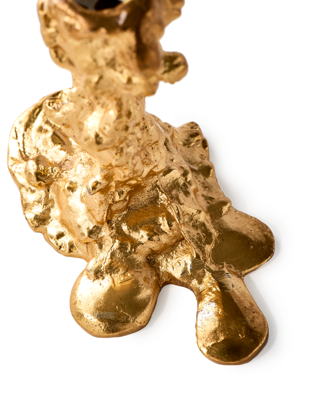 detail of large gold drip decor candle stick holder