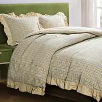 bedroom with green headboard and taupe an grey bedding