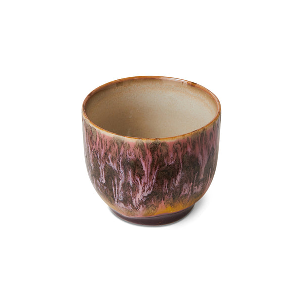 Ceramic cup with a unique glaze pattern on a white background
