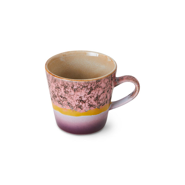 Ceramic mug with a gradient design from pink to purple on a white background