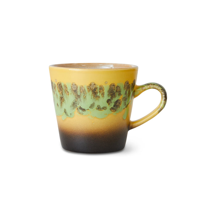 Yellow mug with green pattern on a white background