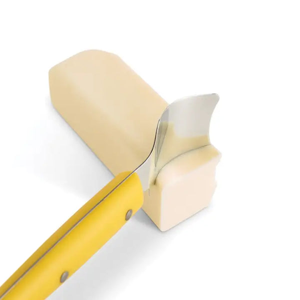 stick of butter with yellow and steel butter knife on white background