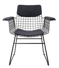 Modern chair with black wire frame and cushioned seat and armrests on a white background