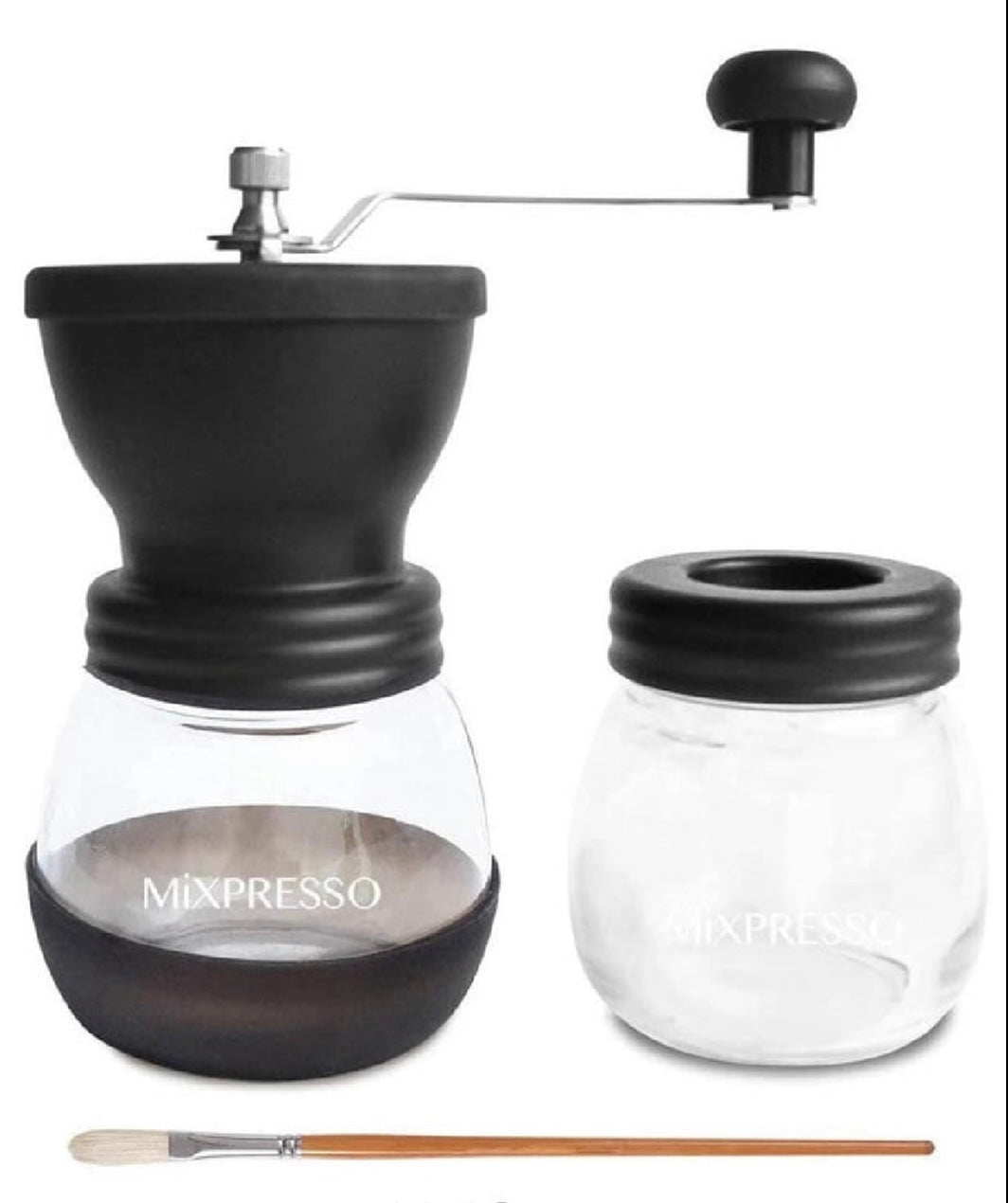 Black manual coffee grinder with clear container and brush on a white background