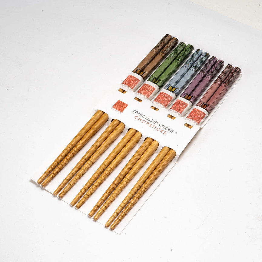 Set of wooden chopsticks with a branded holder on a white background