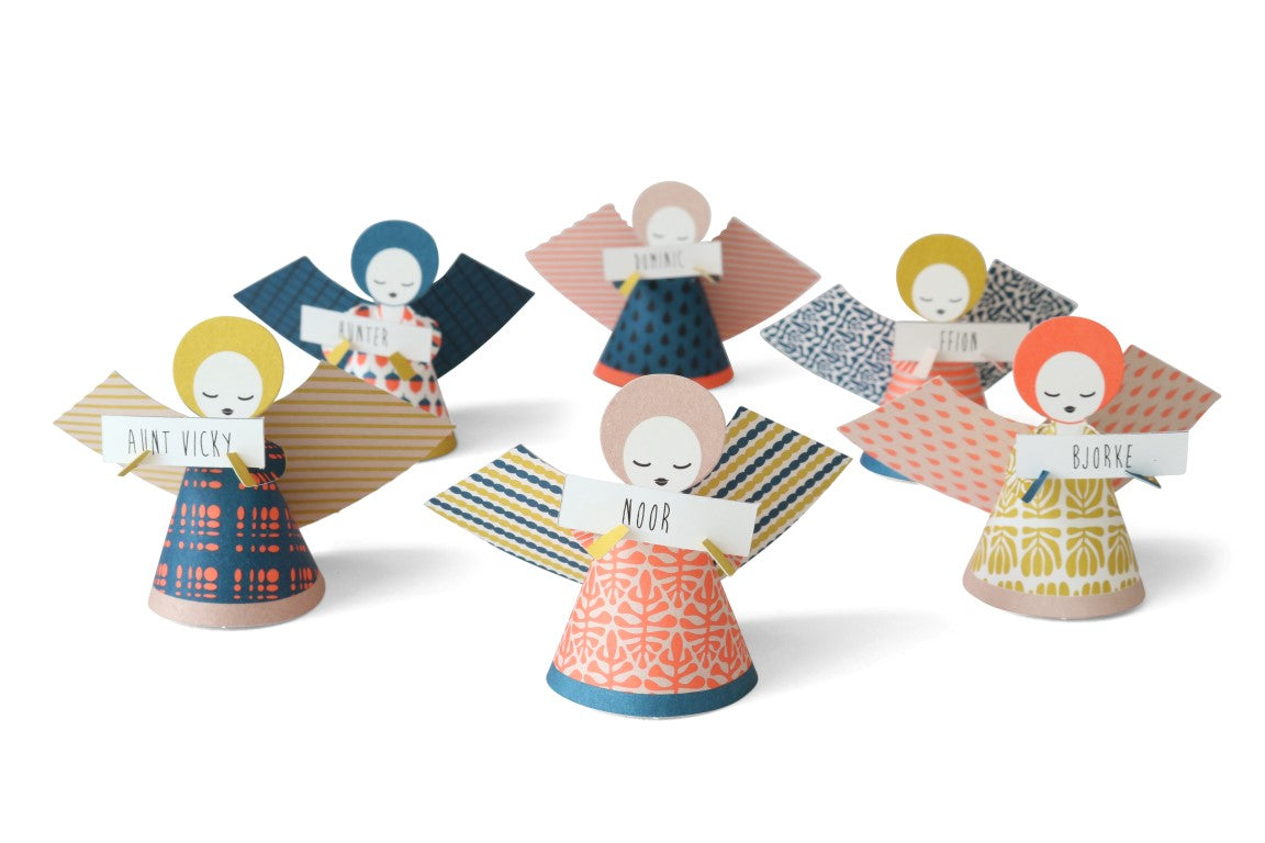Colorful paper angels with different hairstyles and clothing on a white background