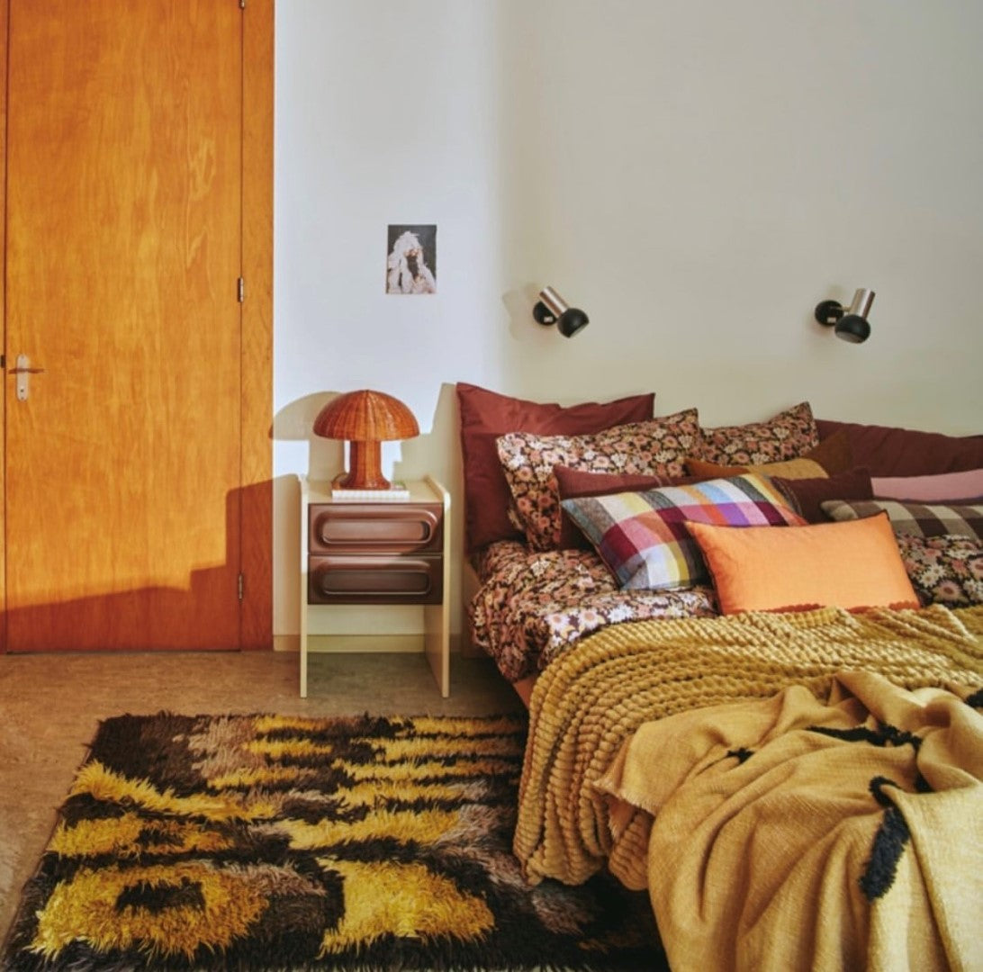 retro style bedroom with cream and brown nightstand with drawers