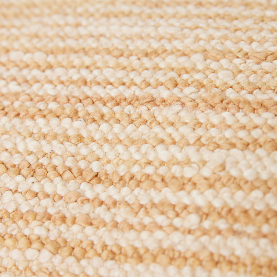 close up of the double sided hand woven pillow in soft blue and light brown