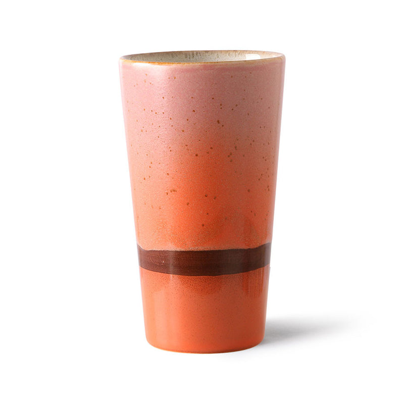 Ceramic tumbler with a gradient color from pink to orange on a white background