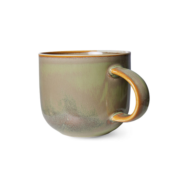 Green ceramic mug with brown handle on a white background