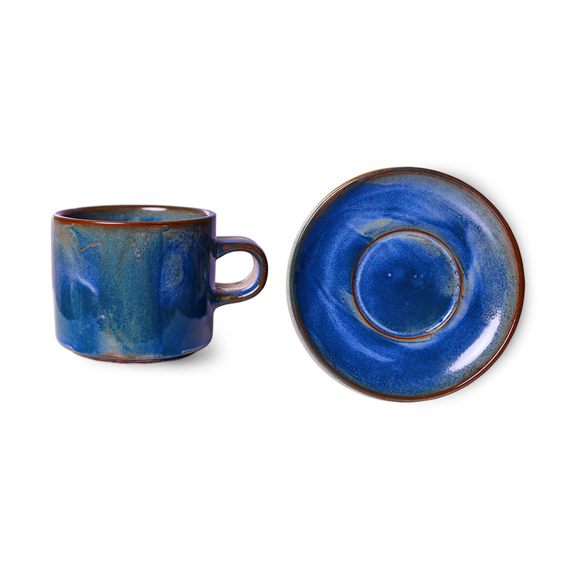 cup and saucer made from porcelain with a rustic blue glazed finish