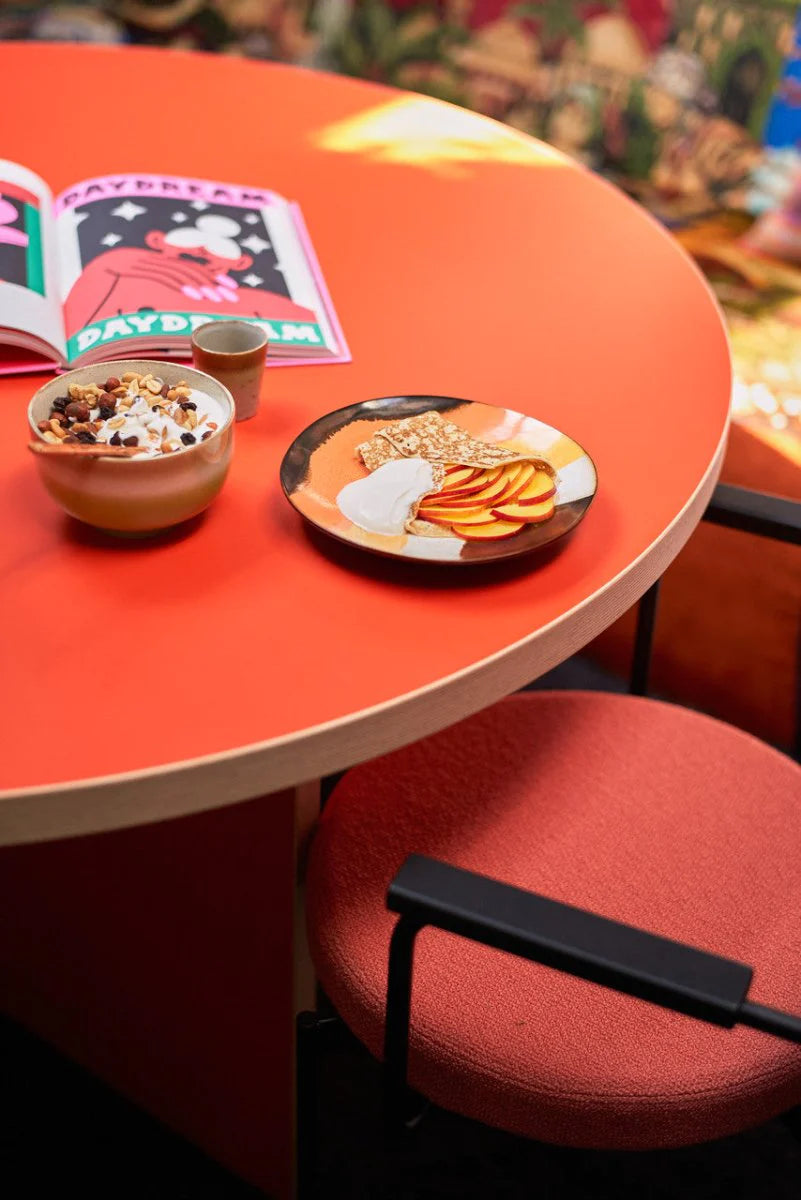 retro style stoneware side plate with fruit on a n orange table