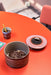 retro style stoneware cookie jar on an orange table