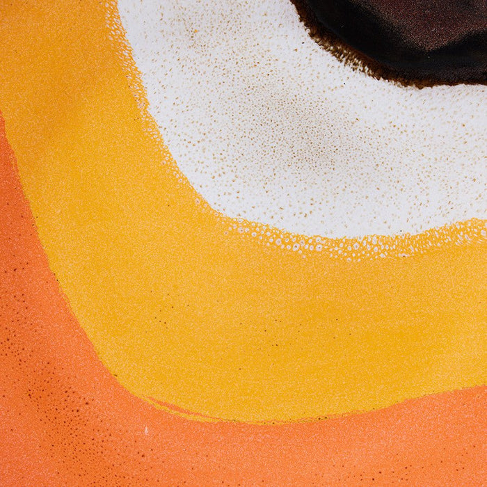 detail of finish from  retro style stoneware dinner plate in orange yellow white and brown