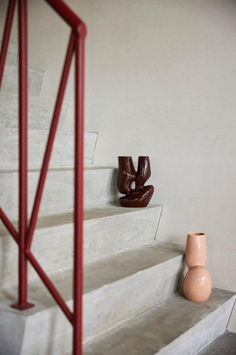 two organic shaped vases on a concrete stairway