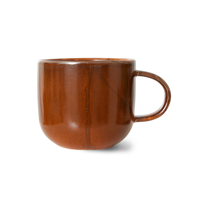 orange brown ceramic mug with ear