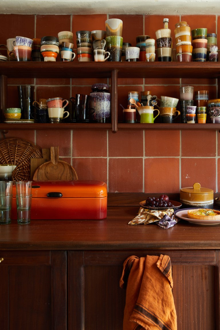 retro style glazed tumbler coffee cups in kitchen with orange brown tiles