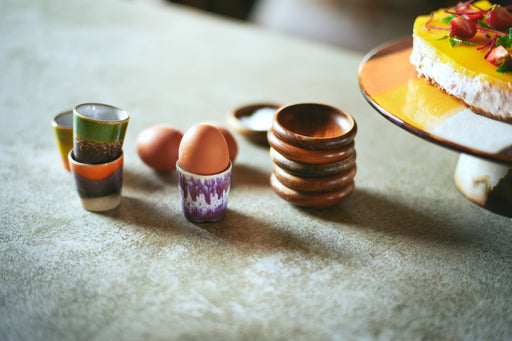 retro style egg cups with hardboiled egg and wooden bowls
