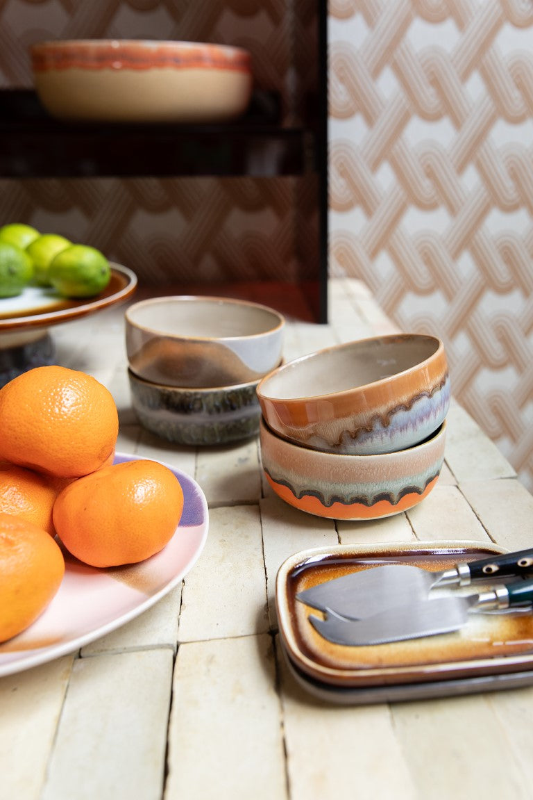 4 retro style dessert bowls with reactive glaze finish on a table with tangerines