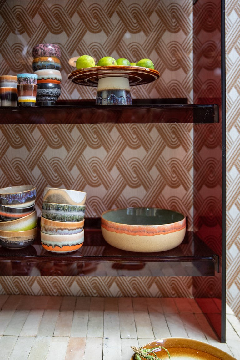 4 retro style dessert bowls with reactive glaze finish in a smoky brown colored open shelving cabinet