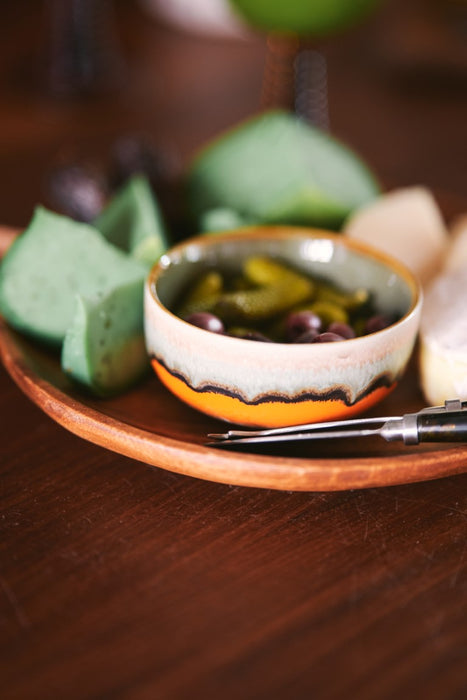 retro style dessert bowl filled with olives and pickles