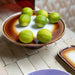 retro style cake stand in brown tints with limes 