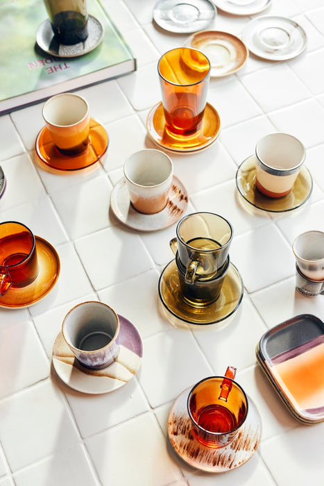 glass coffee cups combined with ceramic saucers