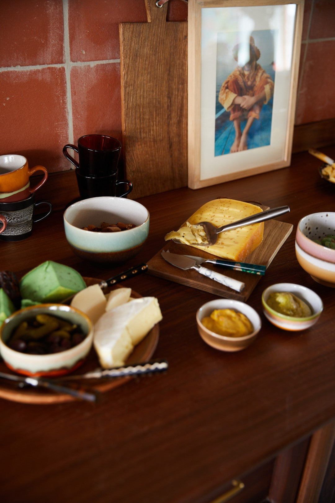 cheese knives in kitchen with cheese and bowls