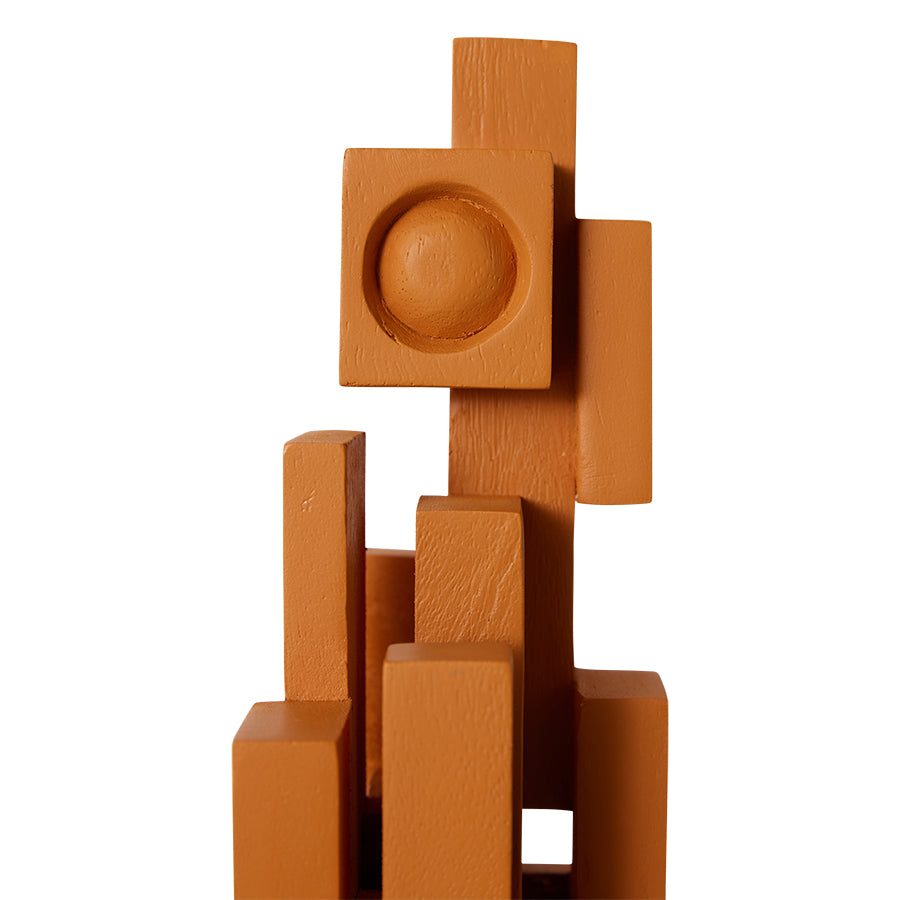 detail of orange painted teak wooden skyline sculpture