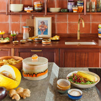 retro style cookie jar in kitchen with orange tiles and brass faucet