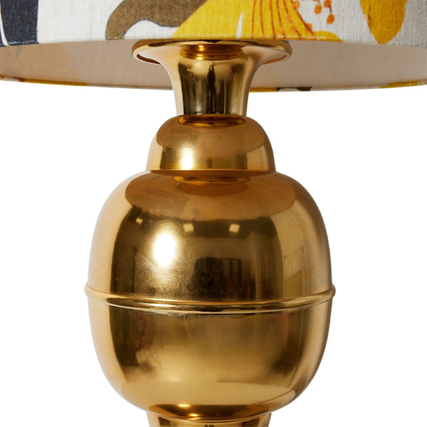 detail of retro style lamp with brass base and floral shade