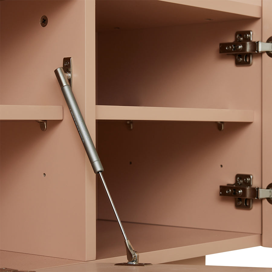 detail of inside blush pink colored entertainment center sideboard