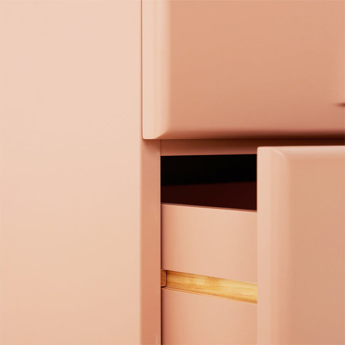 detail of blush colored 2 drawer cabinet