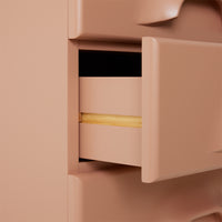 detail of blush colored chest with 7 drawers