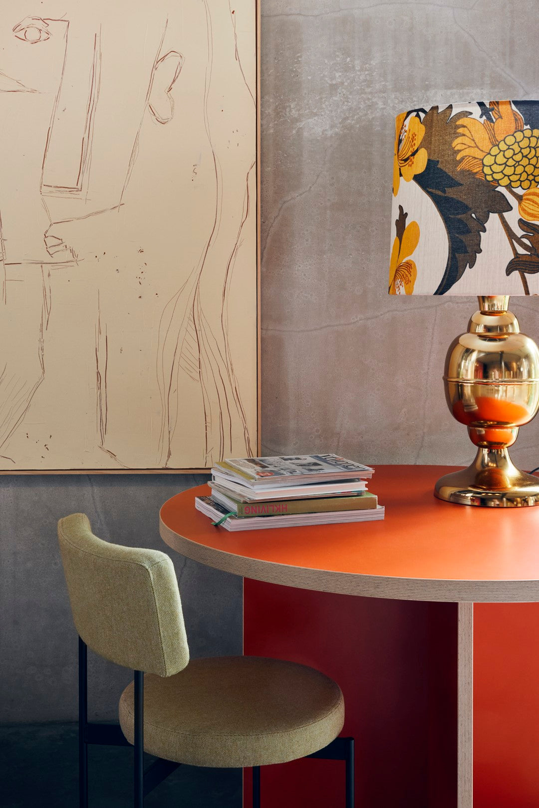 retro style lamp with brass base and floral shade on orange table in modern interior