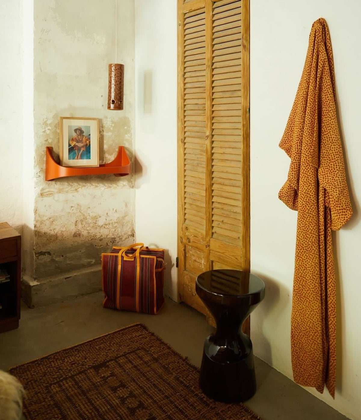 wooden burgundy colored stool in small space