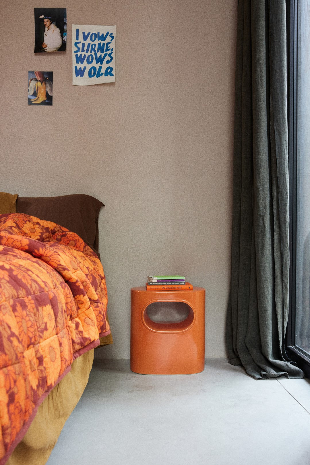 bedroom with orange colored earthenware accent table with open space