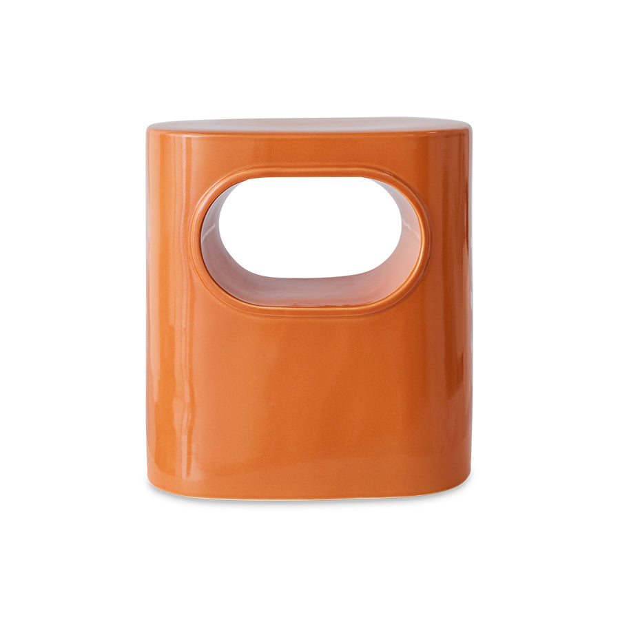 orange colored earthenware accent table with open space