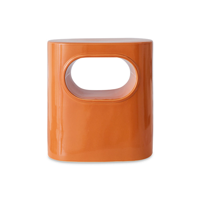 orange colored earthenware accent table with open space