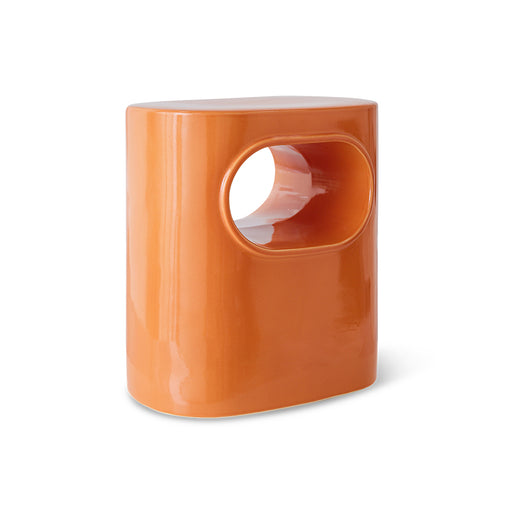 orange colored earthenware accent table with open space