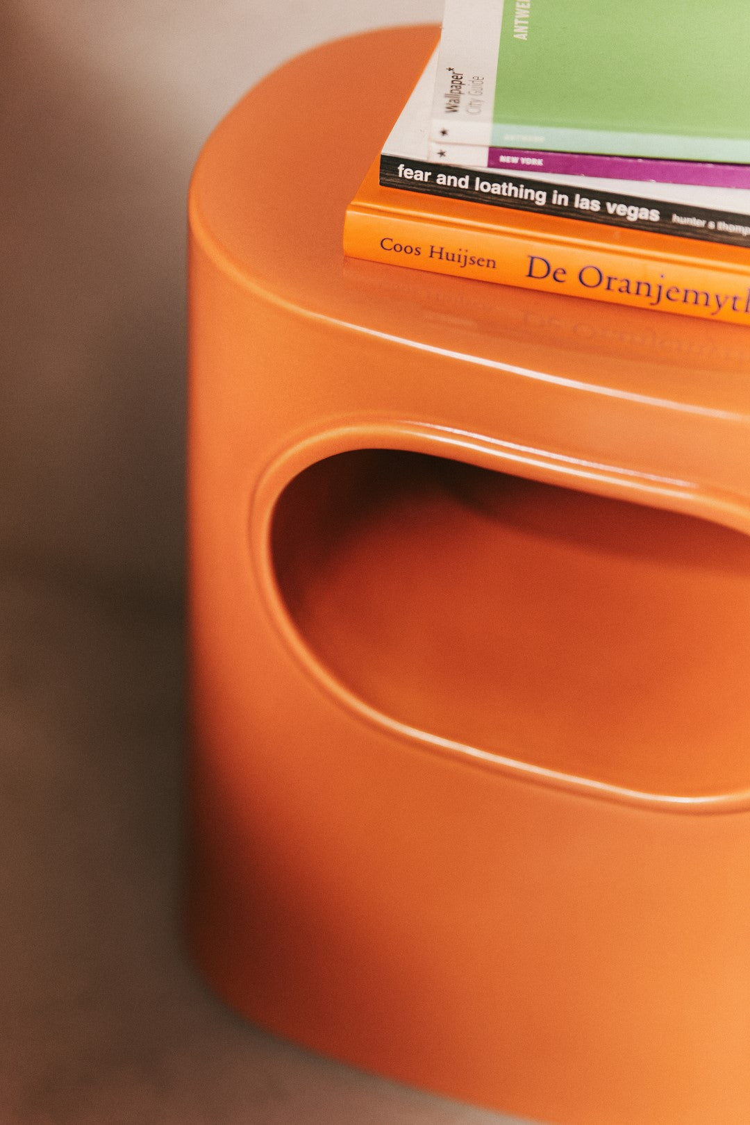 orange colored earthenware accent table with open space
