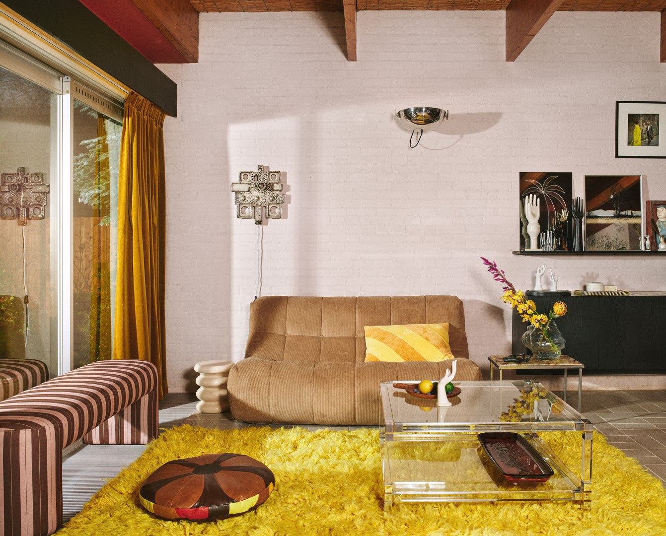 blush and maroon striped upholstered bench in retro style living room with bright yellow area rug