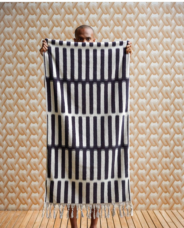 man holding black and white large towel