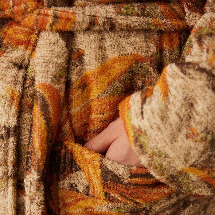 detail of bathrobe with pockets and orange brown palm tree motive