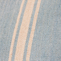 close up of double sided hand woven pillow in soft blue and light brown